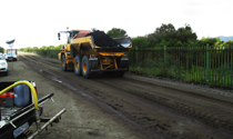 Articulated dump truck on a treated site road