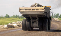 Rear view of haul truck on a treated haul road